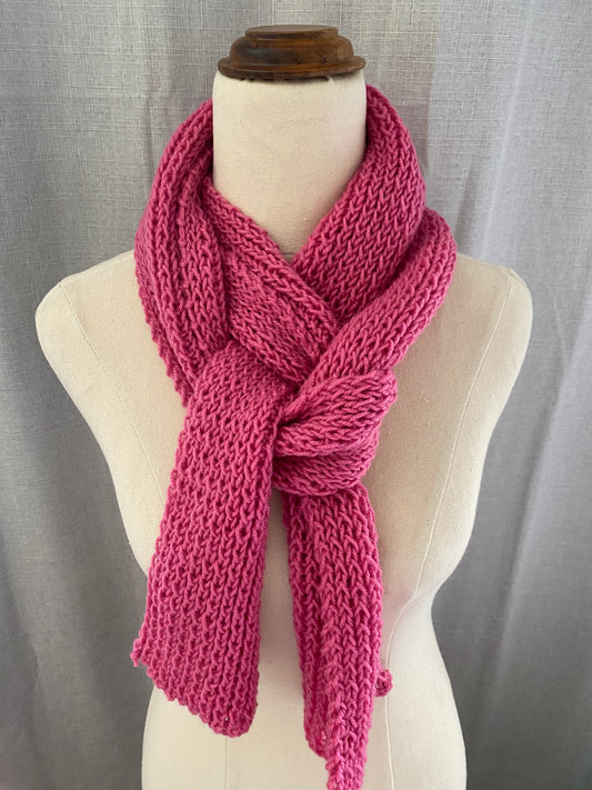 Genuinely hand knitted scarf in berry pink.
