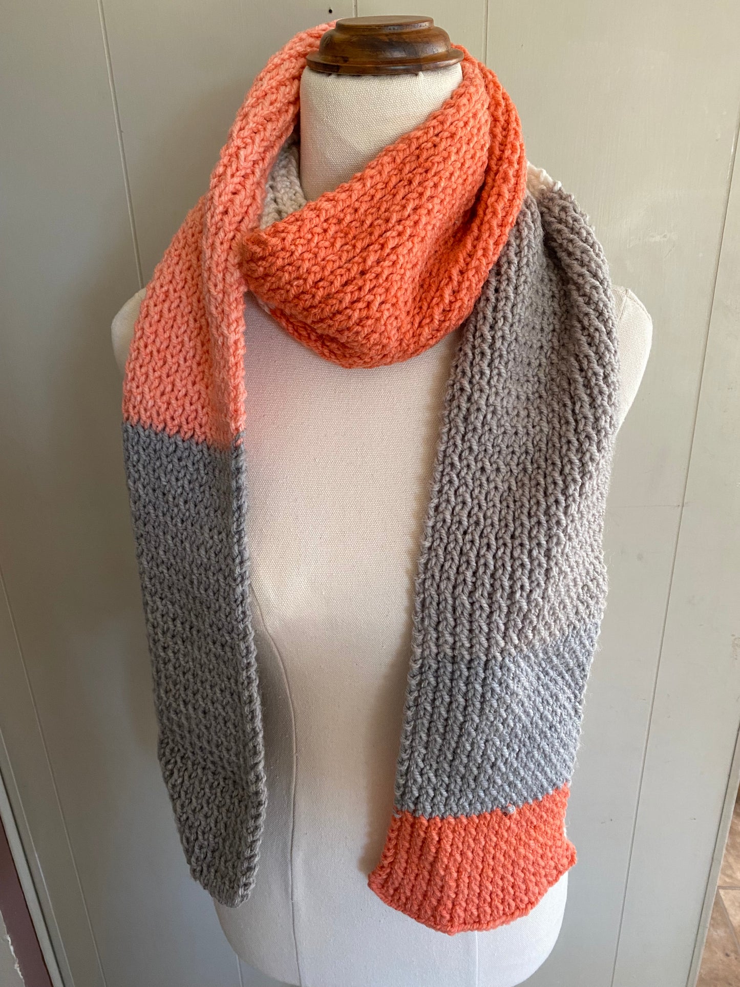 Genuinely hand knitted scarf in salt white, orange and grey