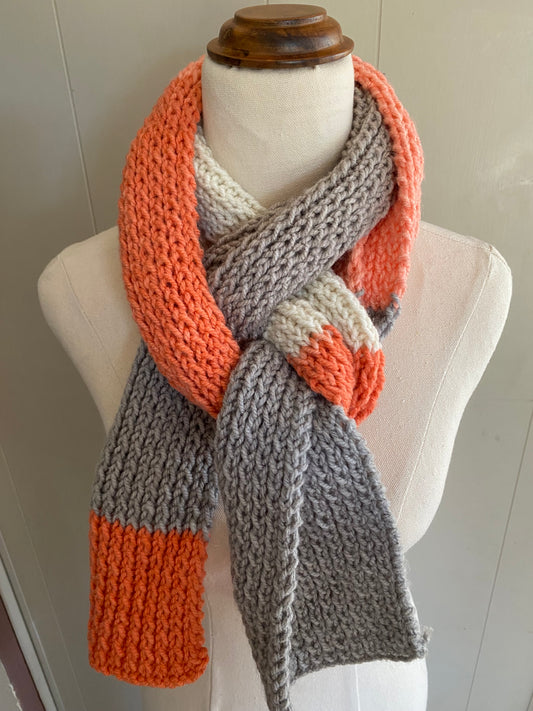 Genuinely hand knitted scarf in salt white, orange and grey